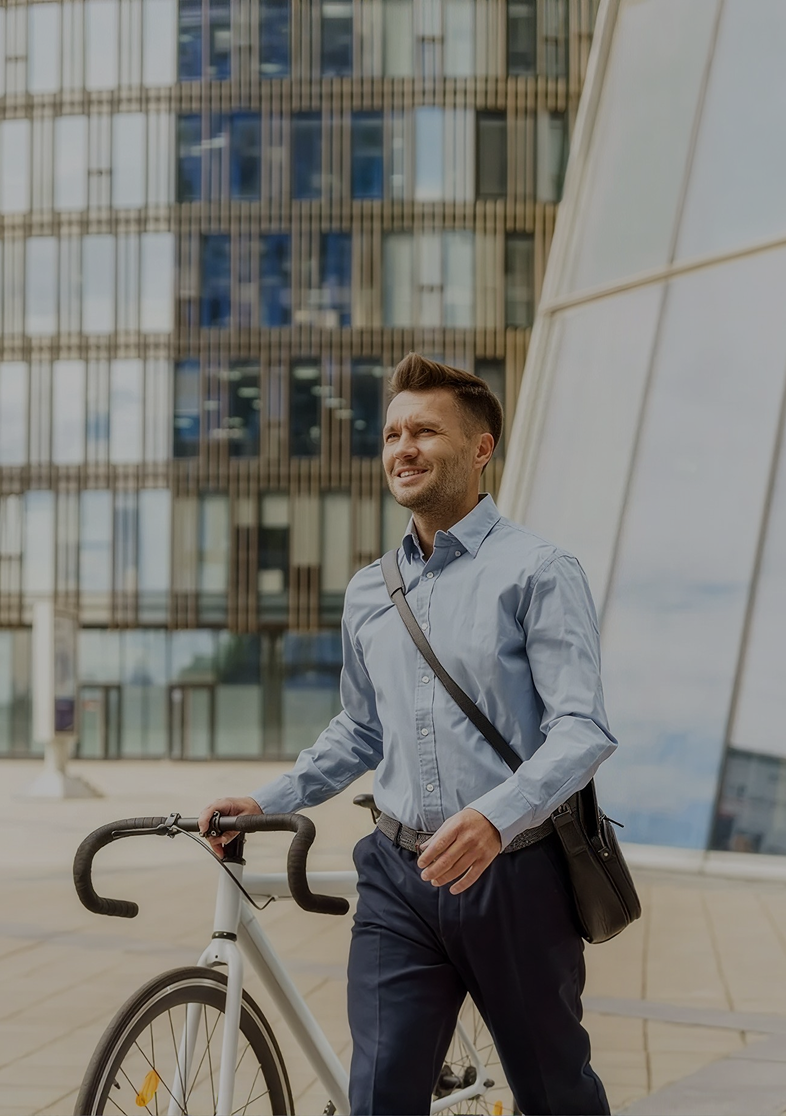 Confident and healthy walking man with a bike