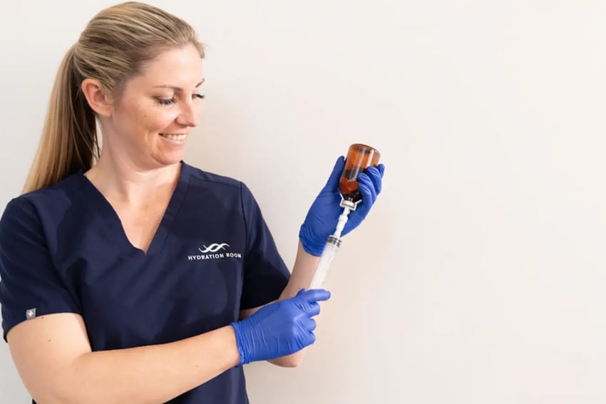 Hydration Room Nurse Drawing Up Vitamins In Syringe
