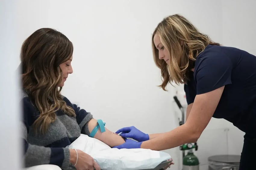 Hydration Room Nurse Inserting IV Placement During Consult