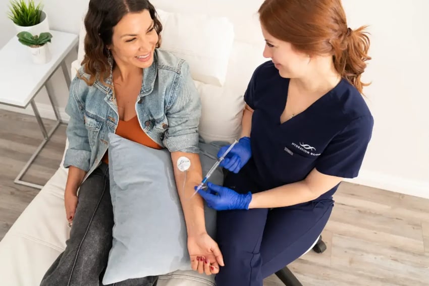 Hydration Room Nurse and Patient Talking While Nurse Inserts Vitamins