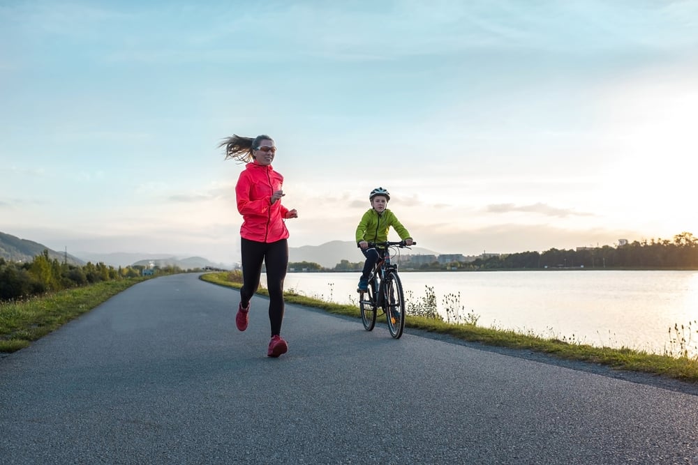 Runner and child on bike