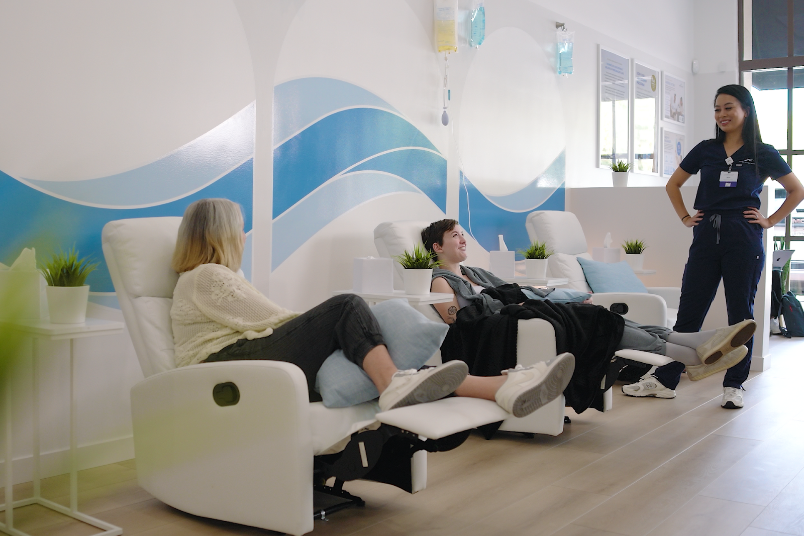 Hallie and her mother chatting with the nurse during IV therapy