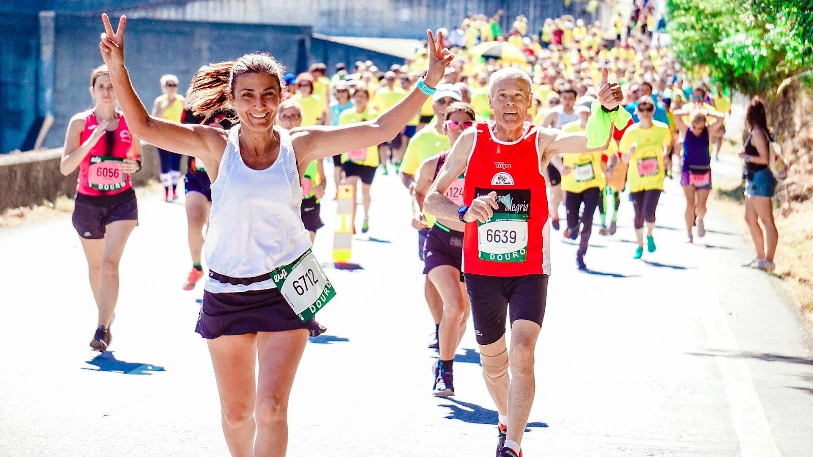 A joyous group of marathon runners on a sunny road