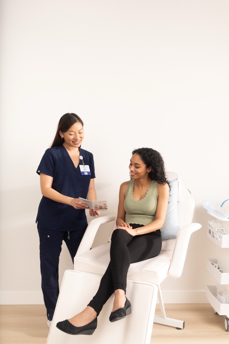 Hydration Room nurse speaking with a patient before an IV session